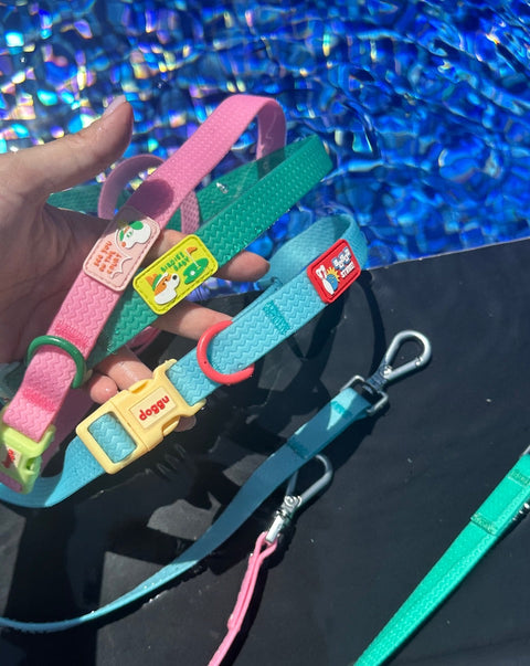 Doggu Sport Club waterproof dog leashes in pink, green and blue held up, showing the themed sport patches